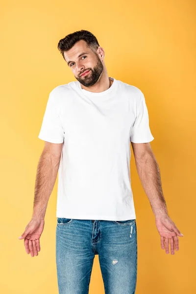Hombre Guapo Sonriente Camiseta Blanca Que Muestra Gesto Dubio Aislado —  Fotos de Stock