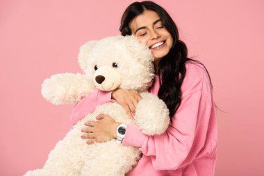 beautiful smiling girl hugging teddy bear, Isolated On pink clipart