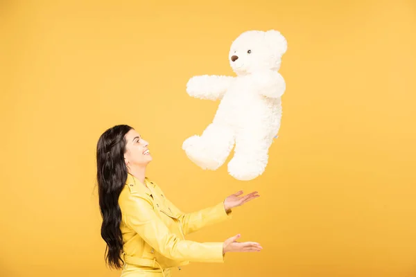 Cheerful Young Woman Throwing Teddy Bear Isolated Yellow — Stock Photo, Image