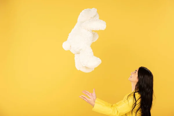 Beautiful Girl Throwing Teddy Bear Isolated Yellow — Stock Photo, Image