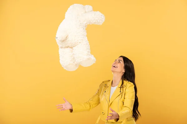 Beautiful Brunette Girl Throwing Teddy Bear Isolated Yellow — Stock Photo, Image