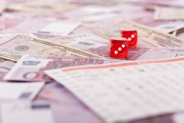 selective focus of dice near betting list on euro and dollar banknotes, sports betting concept clipart