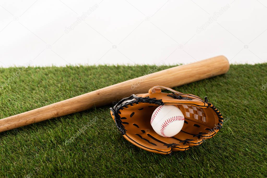 baseball bat, glove and ball on green grass isolated on white, sports betting concept