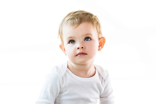 Adorable bebé de ensueño con pelo rubio mirando hacia arriba aislado en blanco - foto de stock