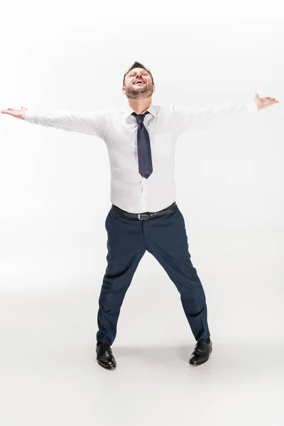 Hombre regordete feliz en ropa formal con las manos extendidas mirando hacia arriba en blanco - foto de stock