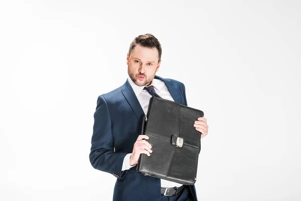 Chubby businessman holding briefcase and looking at camera on white with copy space — Stock Photo