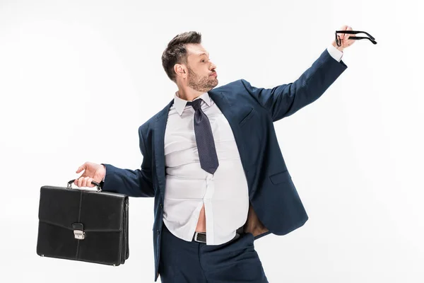 Overweight businessman in tight formal wear with briefcase and glasses isolated on white — Stock Photo