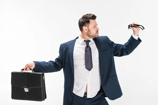 Overweight businessman in tight formal wear holding briefcase and glasses isolated on white — Stock Photo