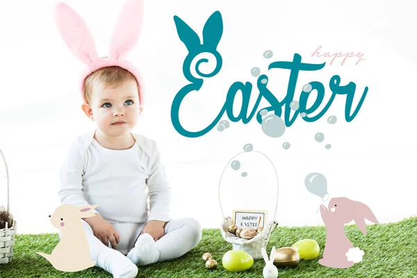 Cute baby in bunny ears headband sitting near painted chicken and quail eggs and Easter illustration — Stock Photo