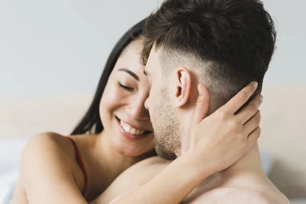 Beautiful, happy asian woman tenderly embracing handsome boyfriend — Stock Photo