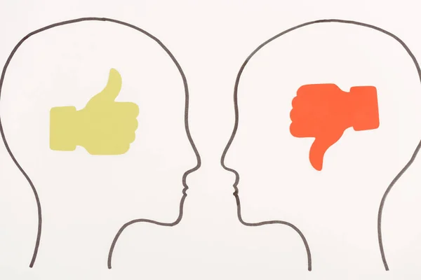 Heads with green thumb up and yellow thumb down isolated on white — Stock Photo