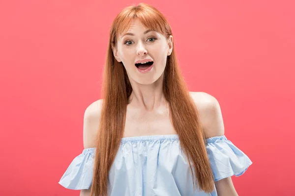 Front view of shocked redhead woman looking at camera with open mouth isolated on pink — Stock Photo