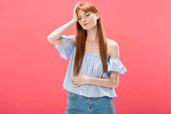 Redhead young woman with headache touching head isolated on pink — Stock Photo