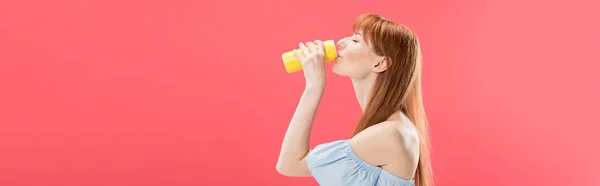 Panoramic shot of redhead girl drinking beverage isolated on pink — Stock Photo