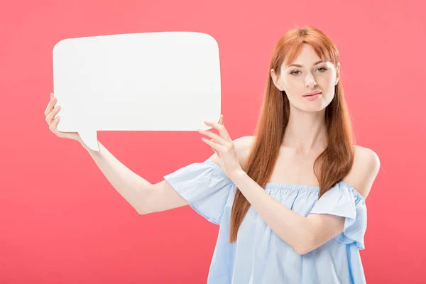 Attractive redhead girl holding empty speech bubble isolated on pink — Stock Photo