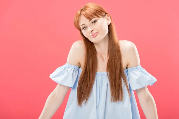Redhead young woman looking at camera and showing shrug gesture isolated on pink — Stock Photo