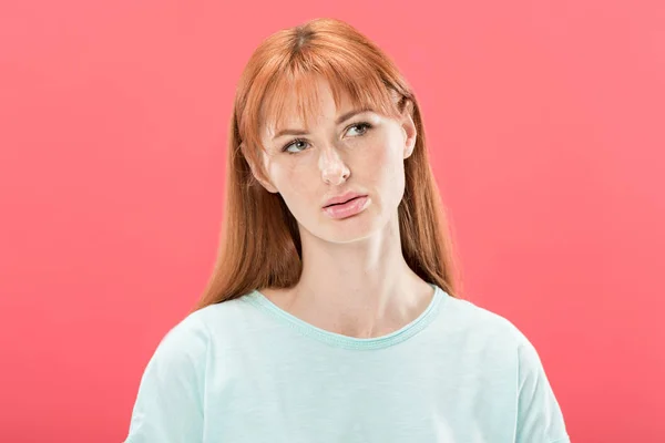 Vorderseite der nachdenklichen rothaarigen jungen Frau, die isoliert auf rosa blickt — Stockfoto