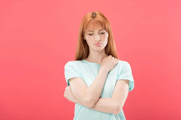 Front view of pensive redhead young woman looking down isolated on pink — Stock Photo