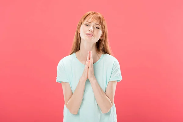 Front view of desperate redhead woman showing please gesture isolated on pink — Stock Photo