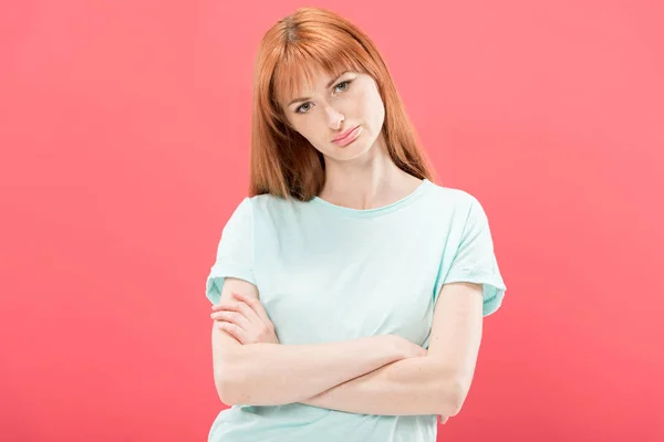 Vorderansicht einer nachdenklichen rothaarigen jungen Frau im T-Shirt, die mit verschränkten Armen isoliert auf pink steht — Stockfoto