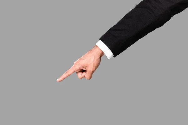 Cropped view of businessman in black suit pointing with finger isolated on grey — Stock Photo