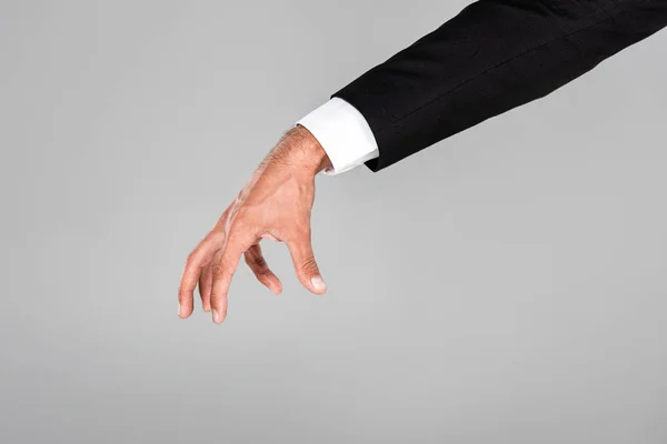 Частичный взгляд бизнесмена на жесты, изолированные на сером — стоковое фото