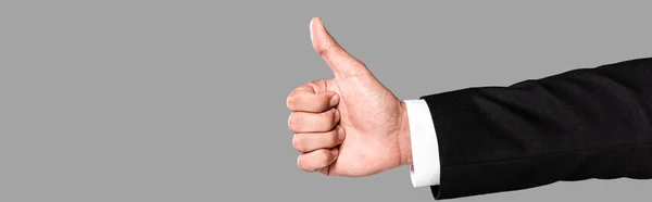 Partial view of businessman in black suit showing thumb up isolated on grey, panoramic shot — Stock Photo