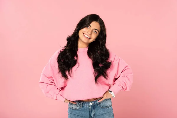 Attractive smiling girl in casual clothing posing isolated on pink — Stock Photo