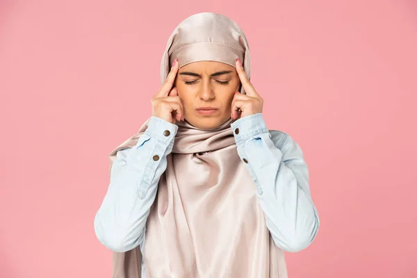 Schöne islamische Mädchen im Hijab mit Kopfschmerzen, isoliert auf rosa — Stockfoto