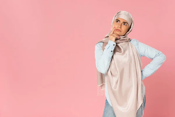 Beautiful pensive muslim woman in hijab, isolated on pink — Stock Photo