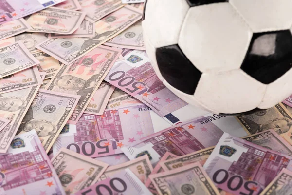 Close up view of soccer ball on euro and dollar banknotes, sports betting concept — Stock Photo