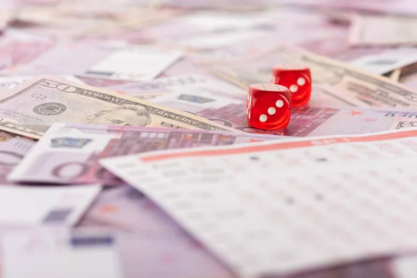 Selective focus of dice near betting list on euro and dollar banknotes, sports betting concept — Stock Photo