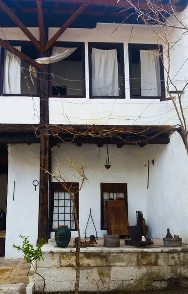 Uma casa popular velha com cortinas brancas encantadoras com culturas velhas — Fotografia de Stock