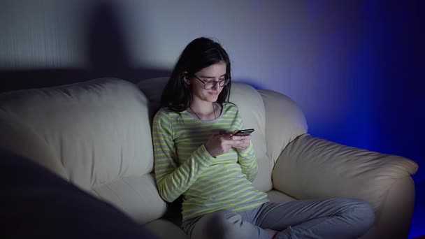 Girl Glasses Sits Couch Next Her Legs Crossed Reads Correspondence — Stock Video