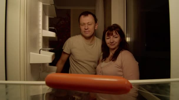 Family Opens Refrigerator Husband Takes Last Sausage Shares His Wife — Stock Video