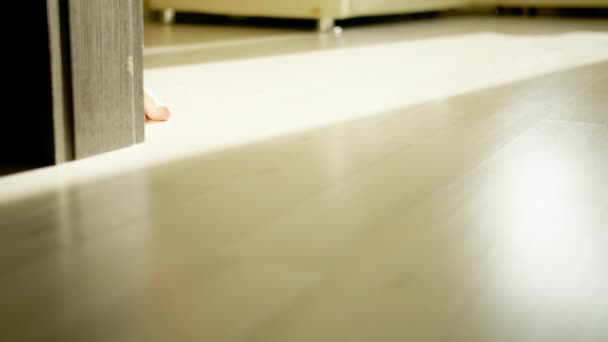 Male legs walk barefoot on the bright floor, camera movement, motion tracking — Stock Footage Male Legs Walk Barefoot Bright Floor Camera Movement Motion Tracking Royalty Free Stock Video