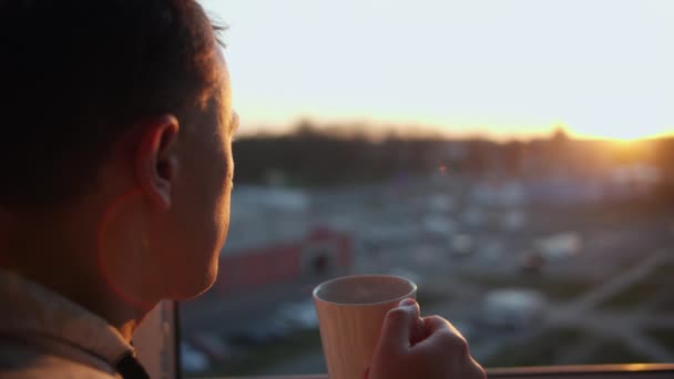 Ελκυστικός Νεαρός Άνδρας Μια Κούπα Ζεστό Ποτό Θαυμάζει Όμορφο Ηλιοβασίλεμα — Αρχείο Βίντεο