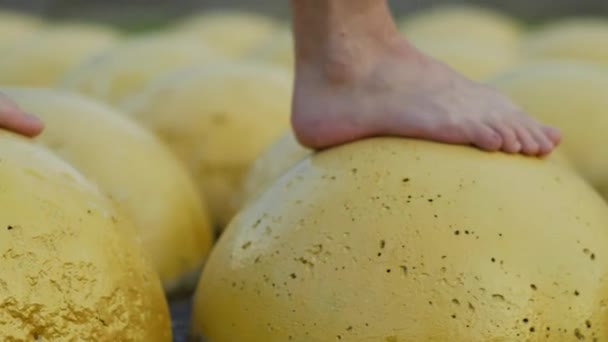 Man Walks Barefoot Yellow Concrete Parking Limiters Camera Movement — Stock Video