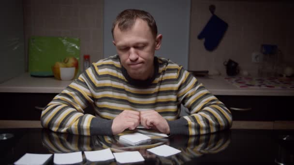 Man Sits Evening Kitchen Front Him Stickers Plans Angrily Tears — Stock Video