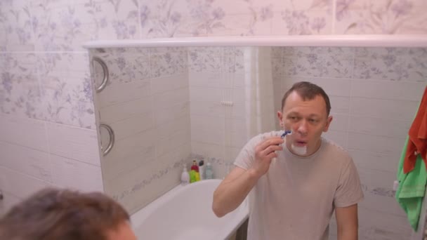 Man Morning Standing Bathroom Mirror Shaves Camera Movement — Stock Video