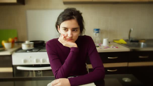 Triste Chica Linda Sentada Una Mesa Sobre Fondo Borroso Cocina — Vídeo de stock