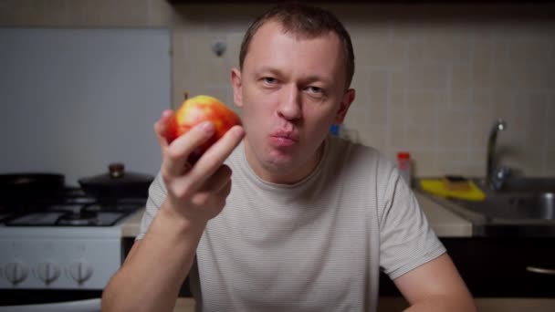 Człowiek Jedzący Soczyste Jabłko Siedzący Przy Stole Kuchni Zdrowo Jedzący — Wideo stockowe
