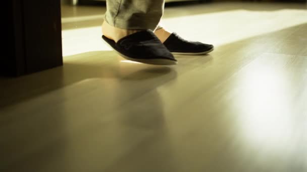 Man Slippers Walks Light Floor Camera Tracking — Stock Video