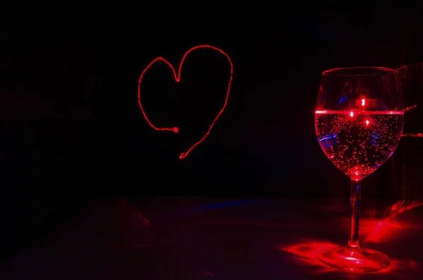 Laser drawn love sign with glassful of bubble drink for party an
