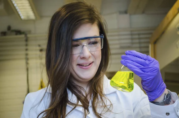 Woman happy scientist holding and paying attention close up to a