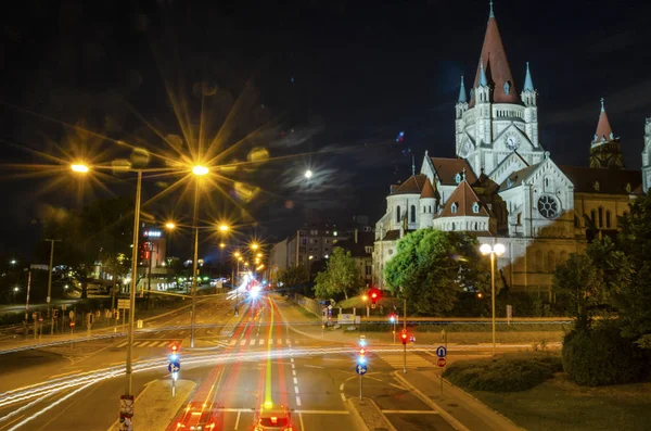 Nightscape cathedral illuminated and car moving light trail long — Stock Photo, Image