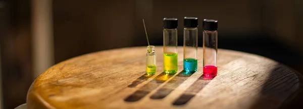 Colourful solutions in different vial with capillary under the light in a chemistry laboratory for healthcare research