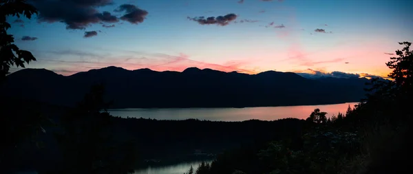 Panorama of mountains, lake and islands during sunset