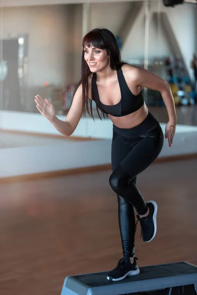 fitness girl trainer in gym in running position