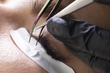 Kirpik uzatma prosedürü. Uzun kirpikli kadın gözü.